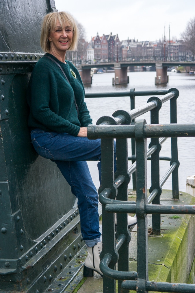 Dark green jumper with a light green brooch
