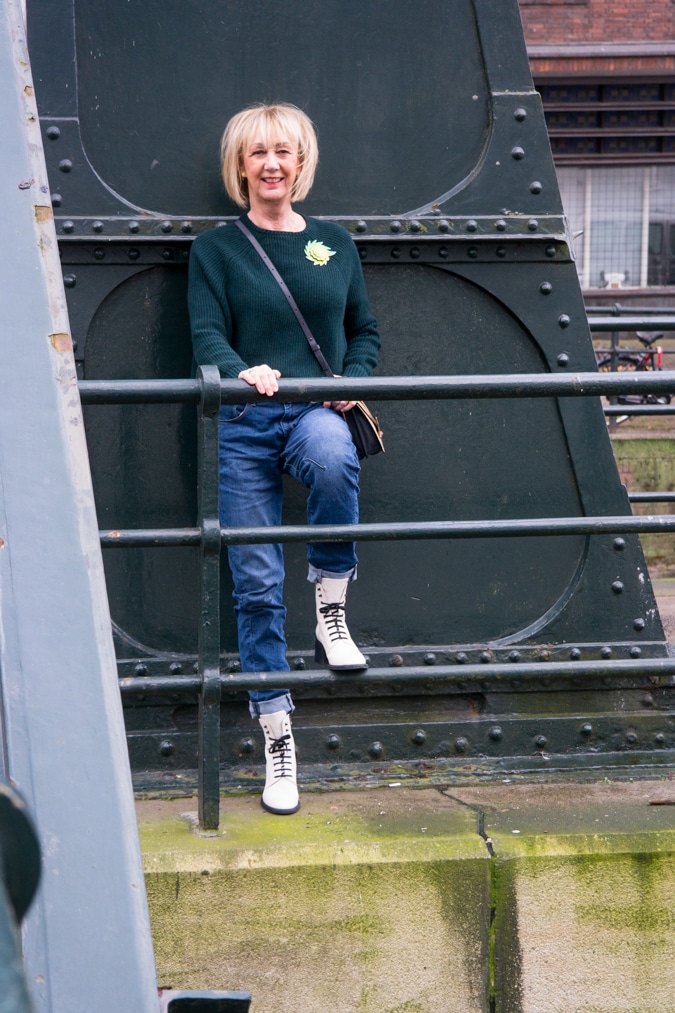 Dark green jumper with a light green brooch