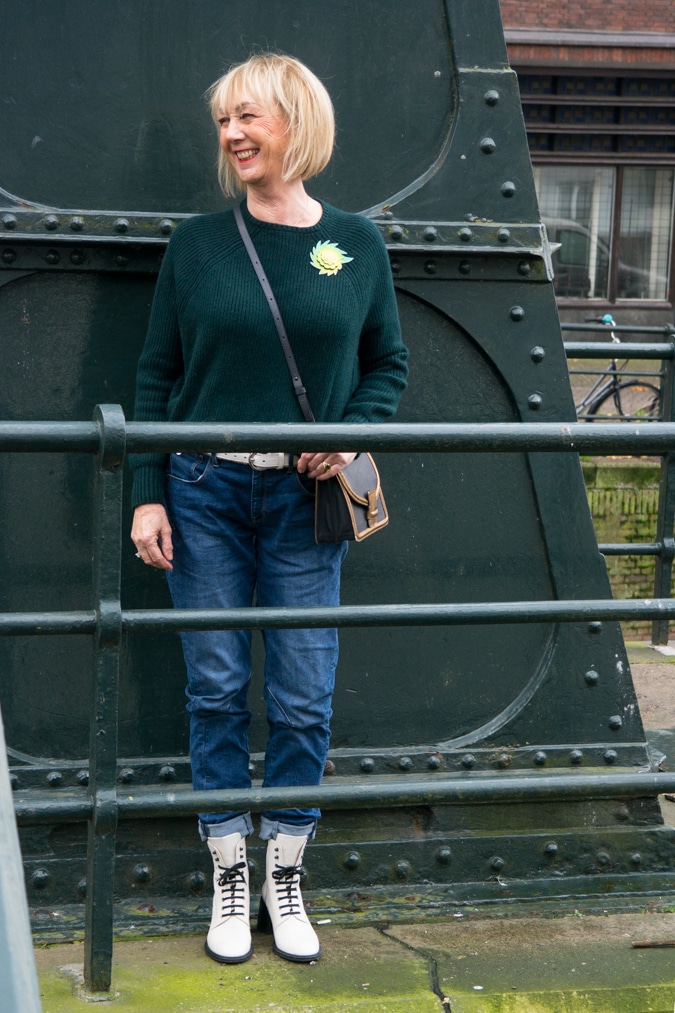 Dark green jumper with a light green brooch