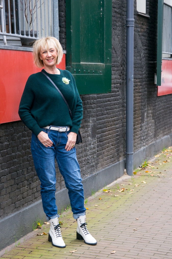 Dark green jumper with a light green brooch