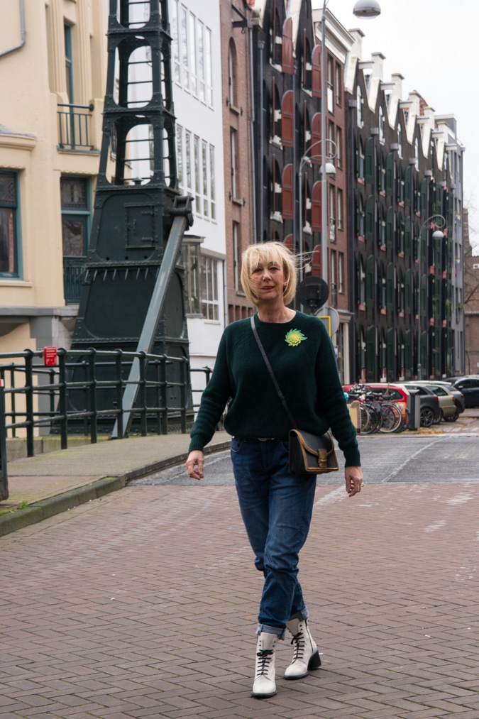 Dark green jumper with a light green brooch