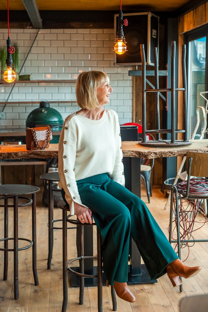 Cream jumper on wide green trousers