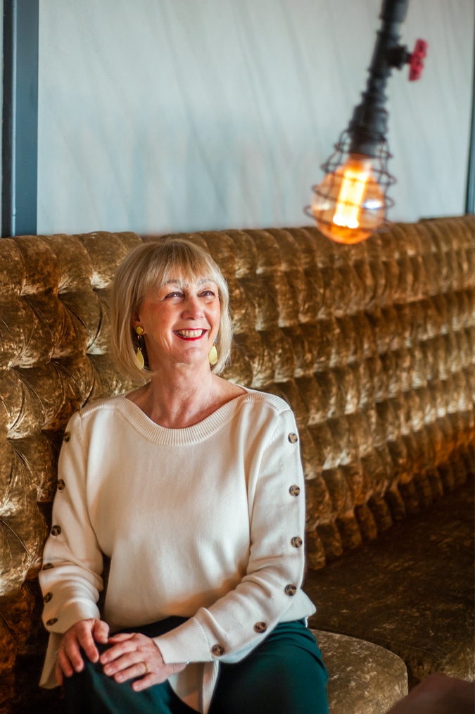 Cream jumper on wide green trousers
