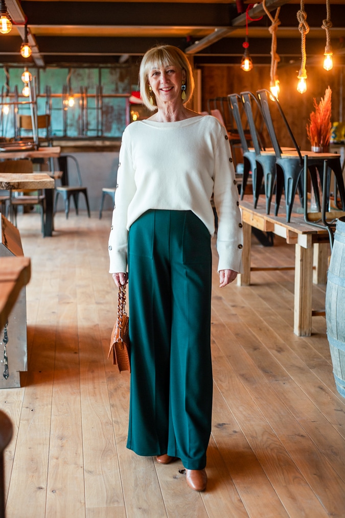 Cream jumper on wide green trousers