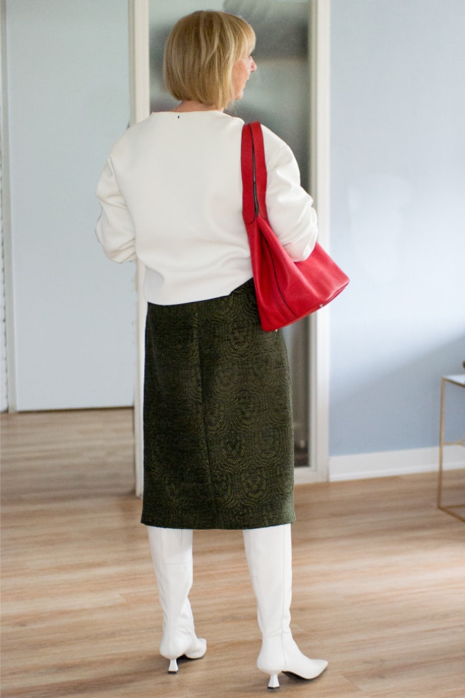 green midi skirt with a cream sweater