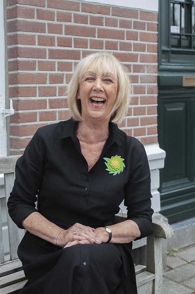 Black linen dress with green brooch by Sylvia Blickman