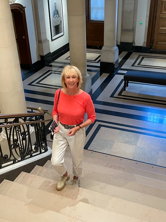 Coral jumper with white trousers