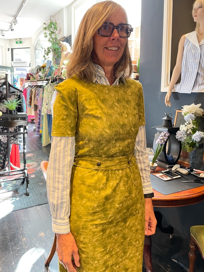 Katrien trying on a dress plus shirt at Lionheart Vintage in Leiden