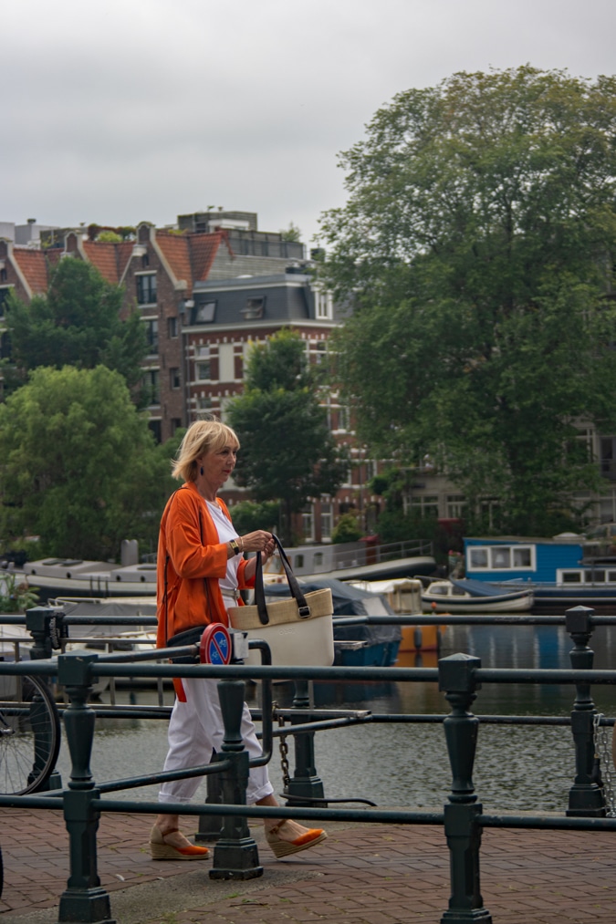 orange jacket with white trousers