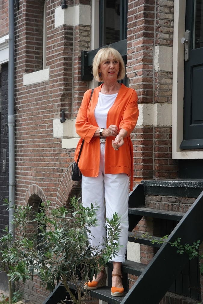 orange jacket with white trousers