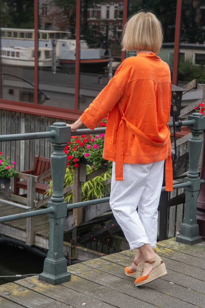 orange jacket with white trousers