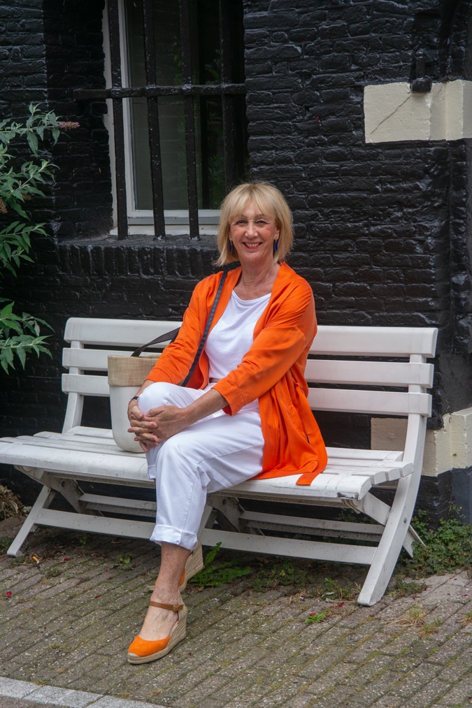 orange jacket with white trousers