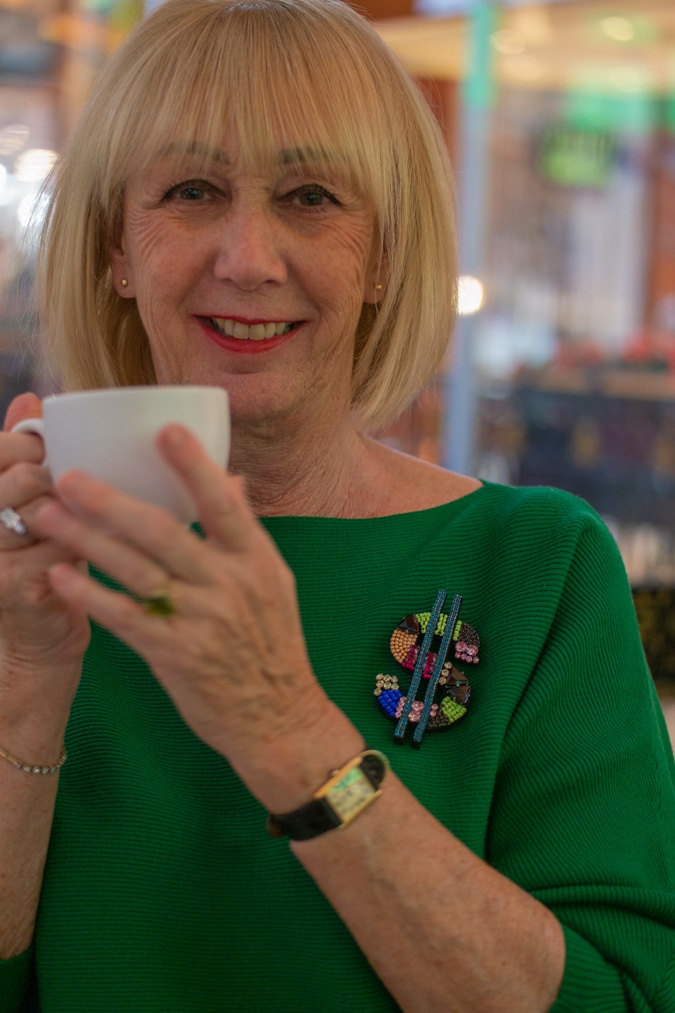 Green jumper with $ brooch