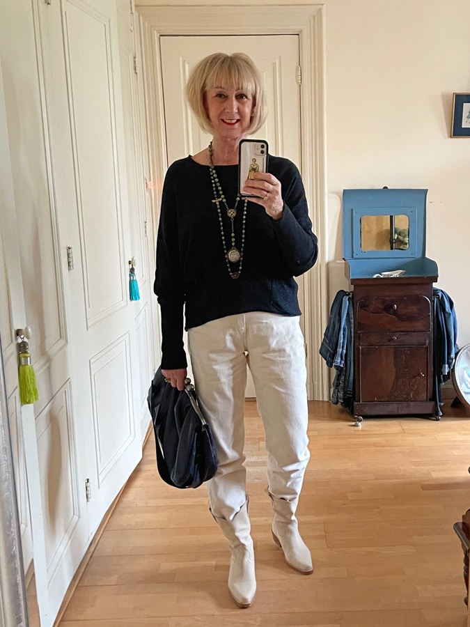 Blue jumper on cream-coloured trousers