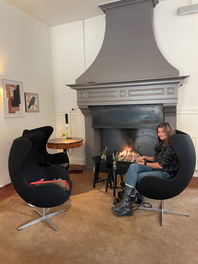 Kitty sitting by the fire at Groenendaal