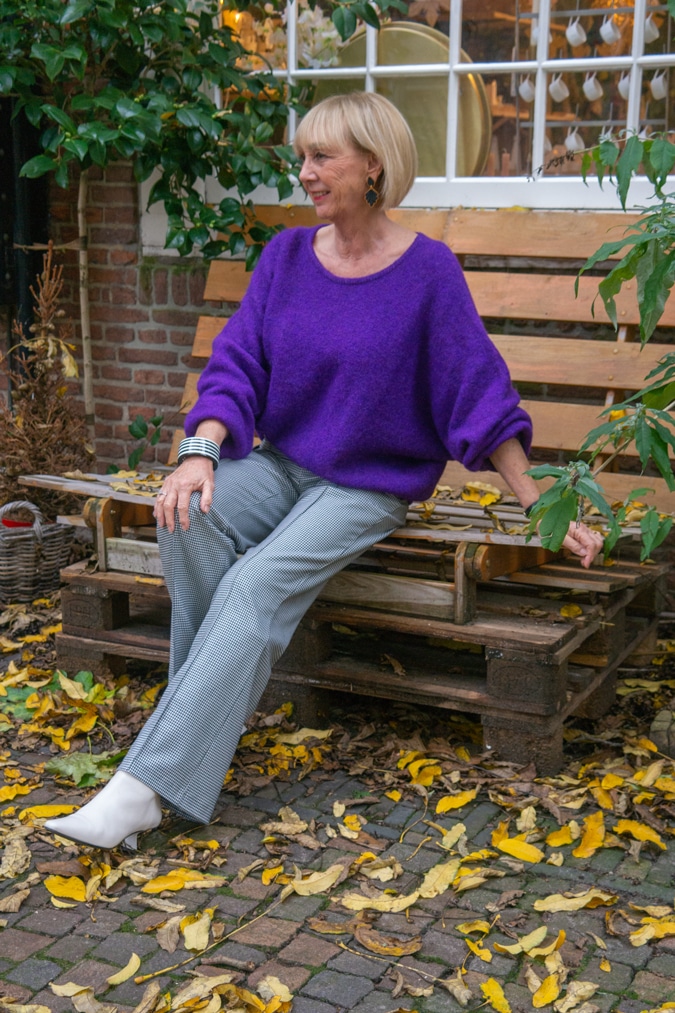 Houndstooth trousers with a purple jumper (sweater)