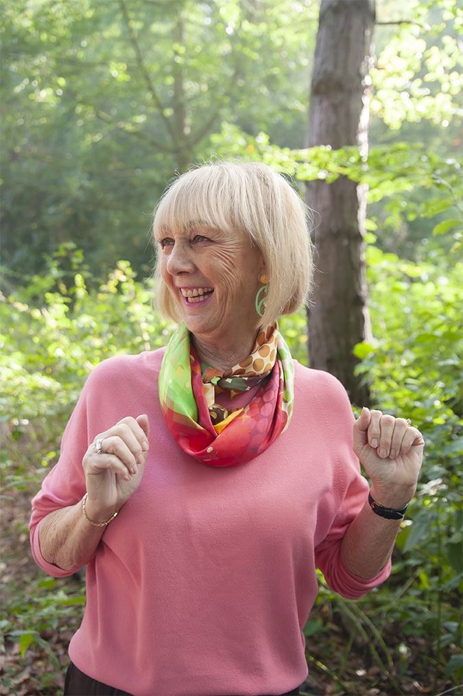 Pink jumper with multi-coloured scarf