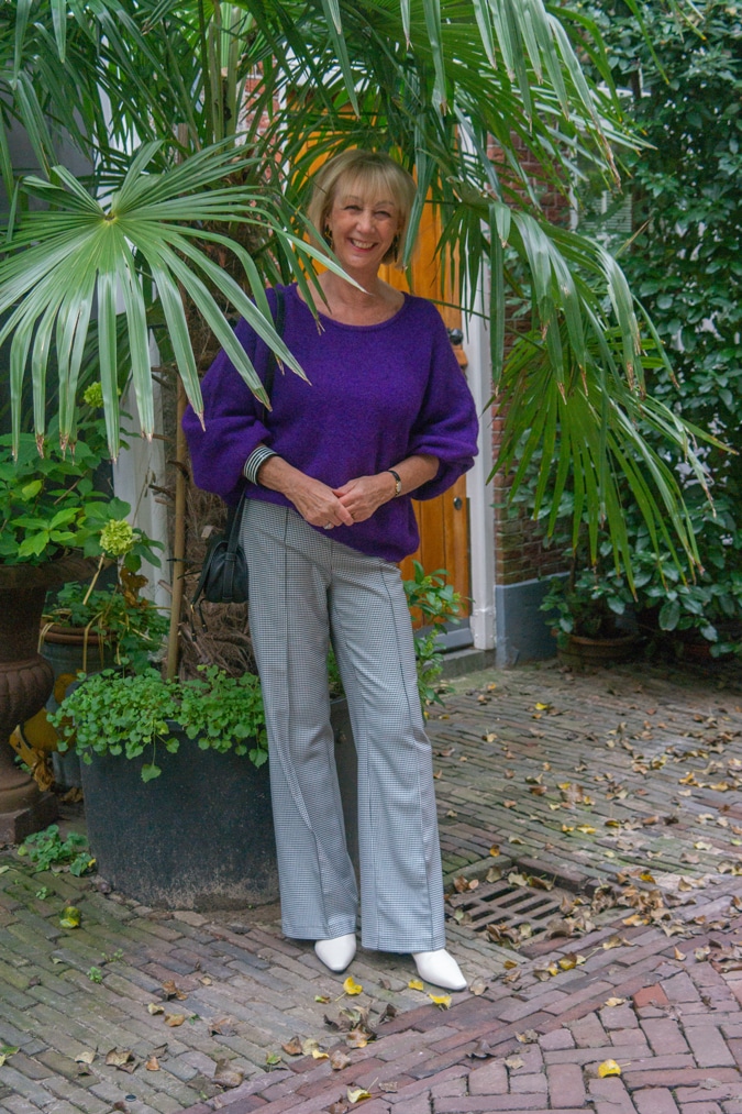 Houndstooth trousers with a purple jumper (sweater)