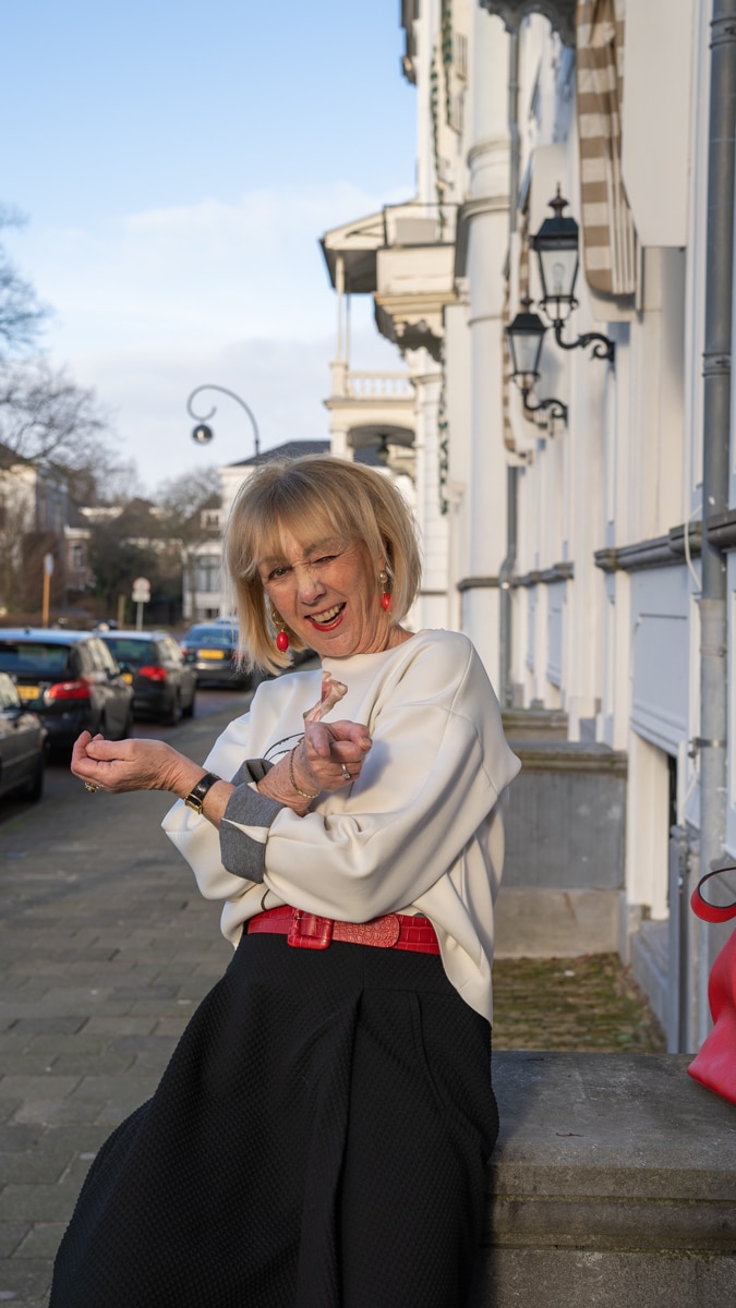 Flared black midi skirt styled in a modern way