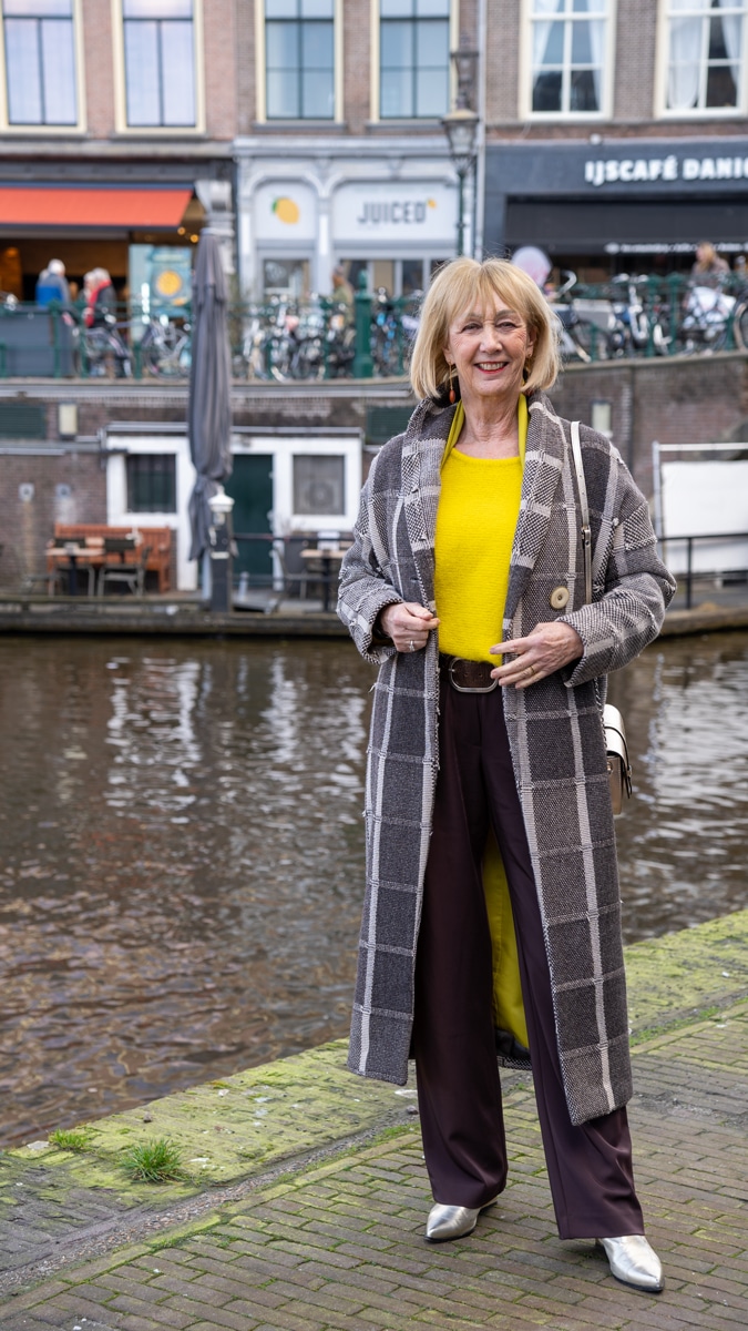 Big yellow jumper and a brownish black coat