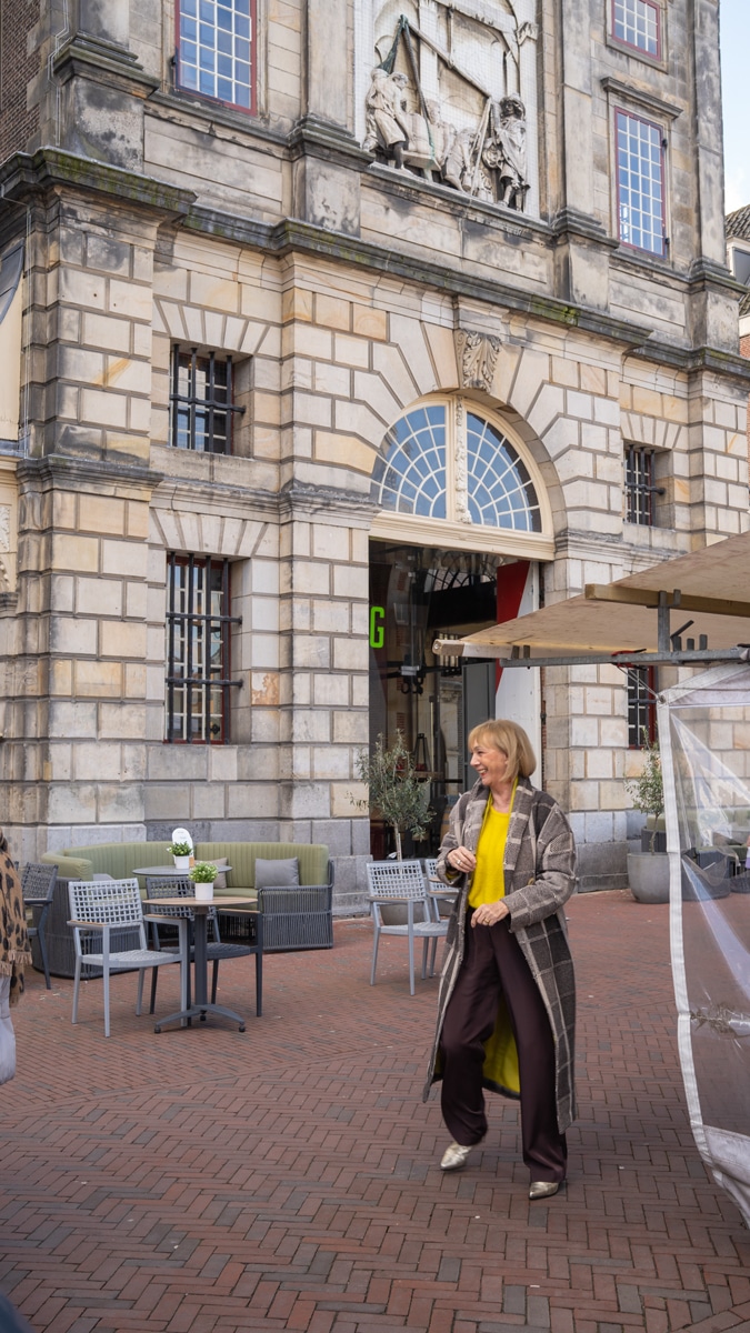 Big yellow jumper and a brownish black coat
