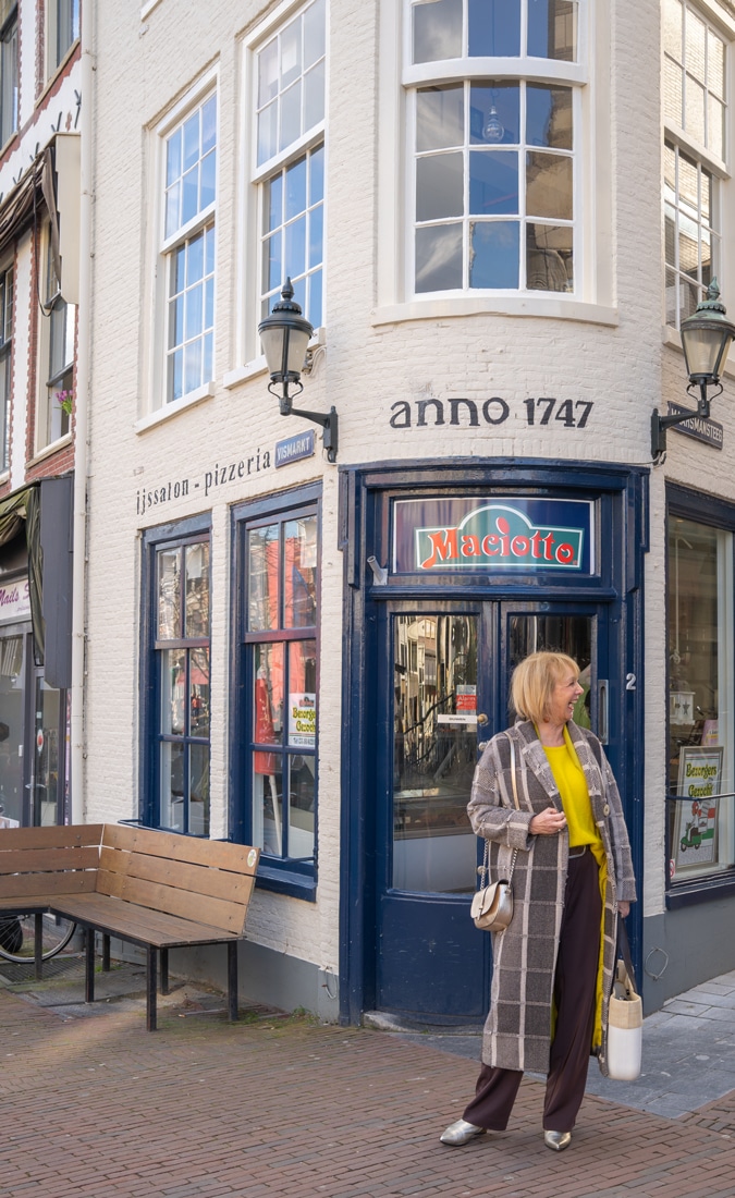 Big yellow jumper and a brownish black coat