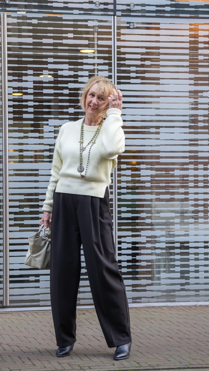 Wide black trousers with a soft yellow jumper