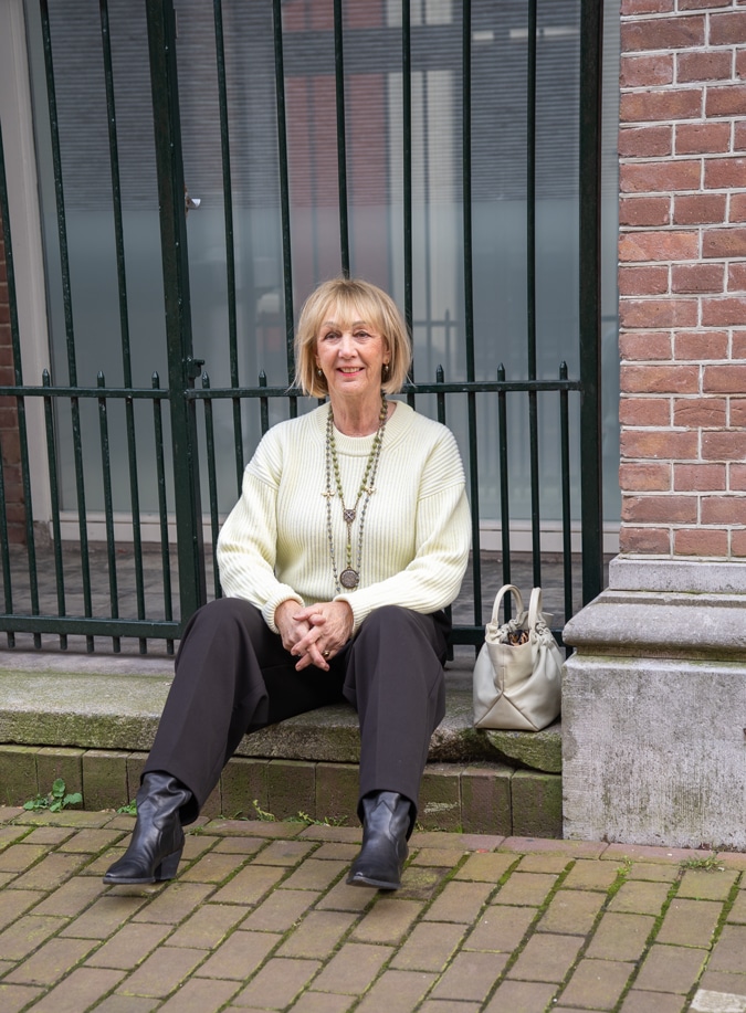 Wide black trousers with a soft yellow jumper