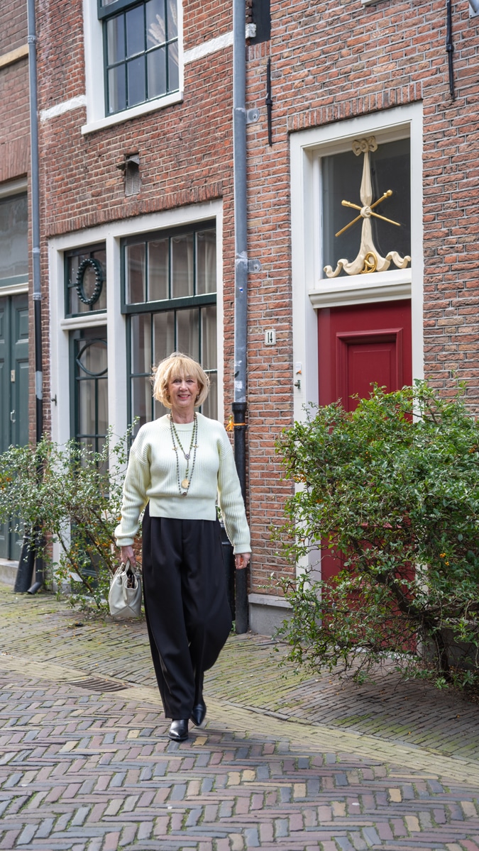 Wide black trousers with a soft yellow jumper