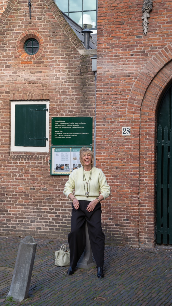 Wide black trousers with a soft yellow jumper