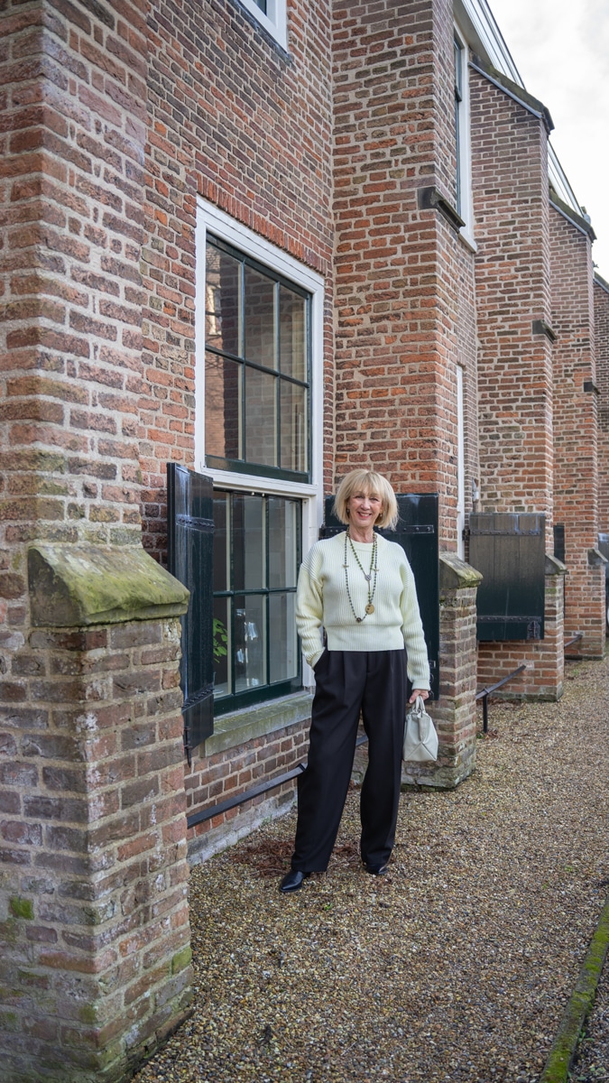Wide black trousers with a soft yellow jumper