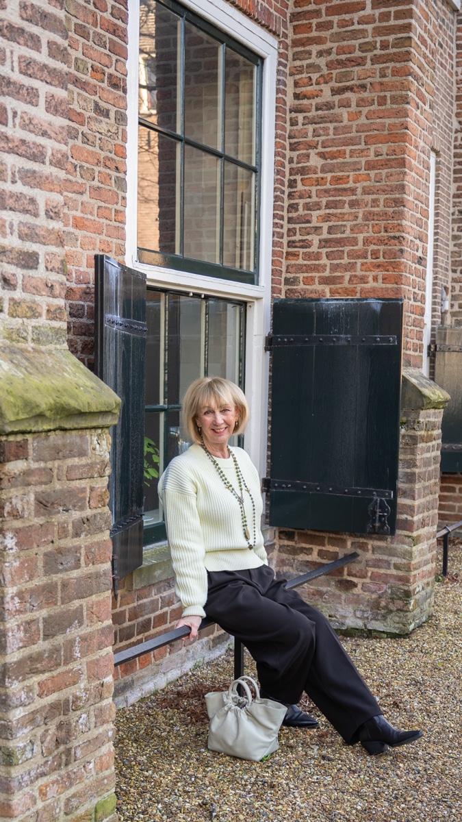 Wide black trousers with a soft yellow jumper