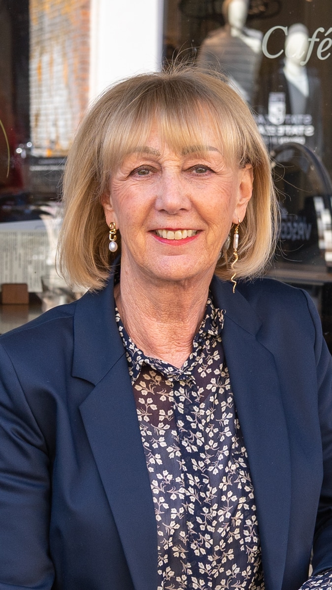 Navy blue blazer with cream trousers