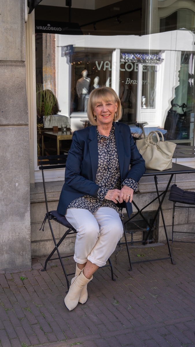 Navy blue blazer with cream trousers