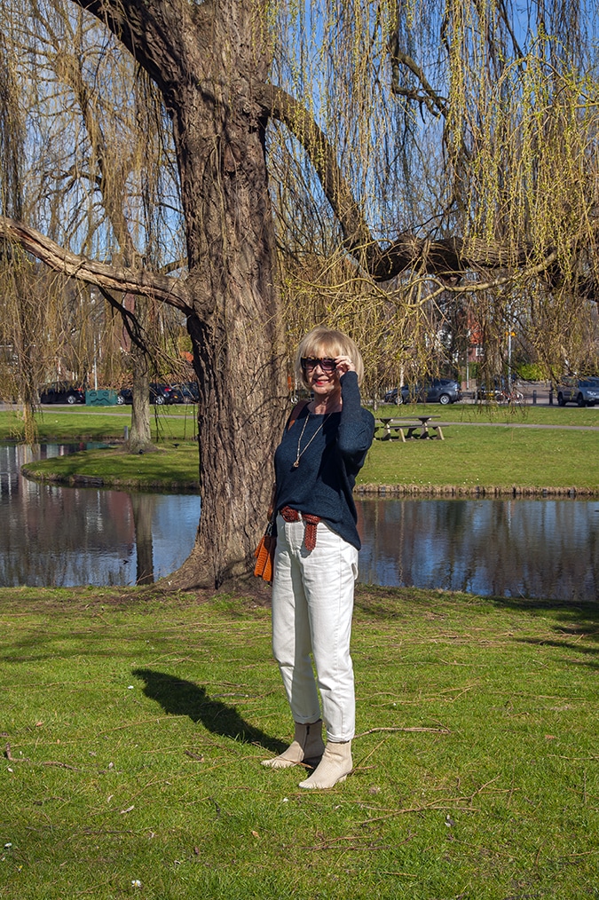 Navy blue jumper with cream trousers
