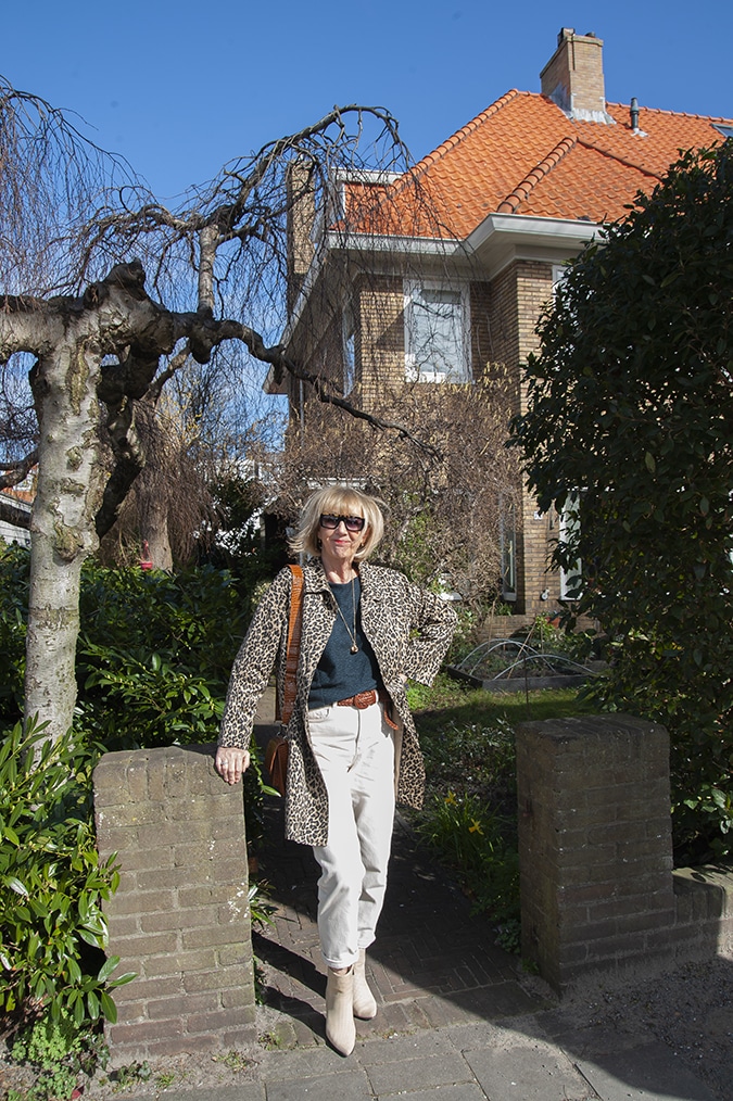 Navy blue jumper with cream trousers and a leopard coat