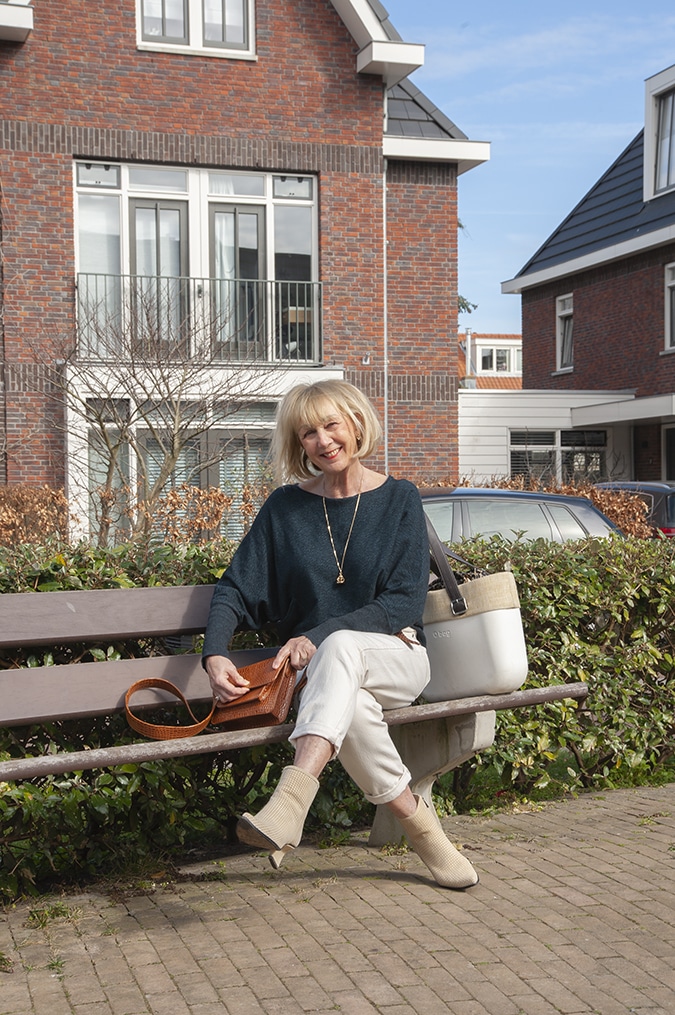 Navy blue jumper with cream trousers