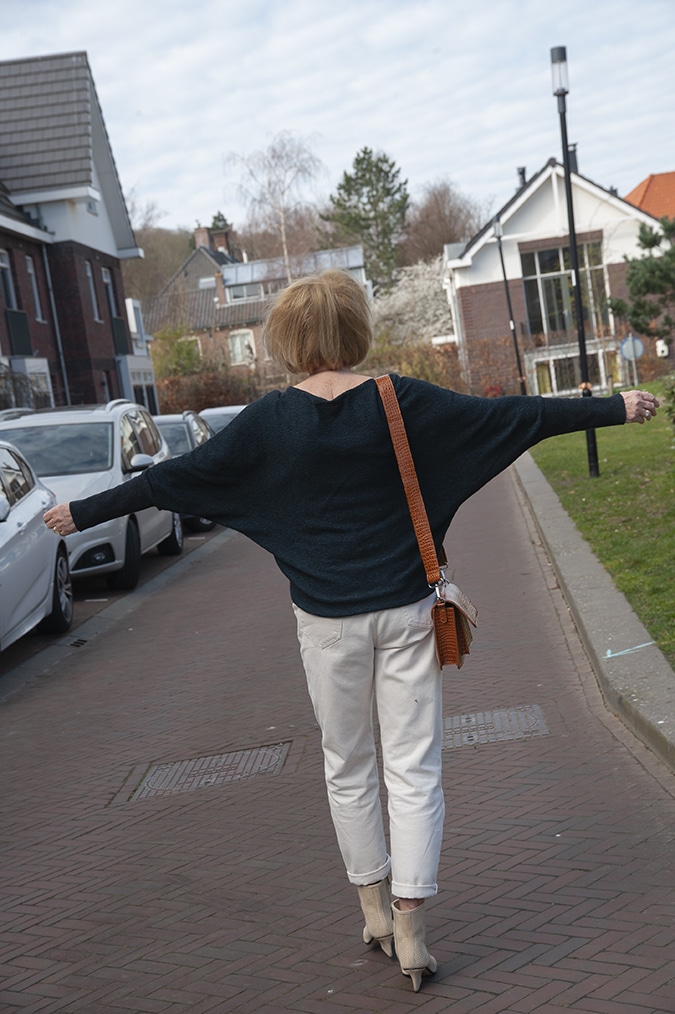 Navy blue jumper with cream trousers