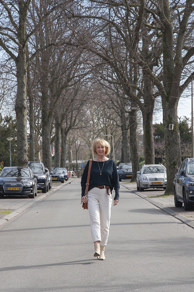 Navy blue jumper with cream trousers