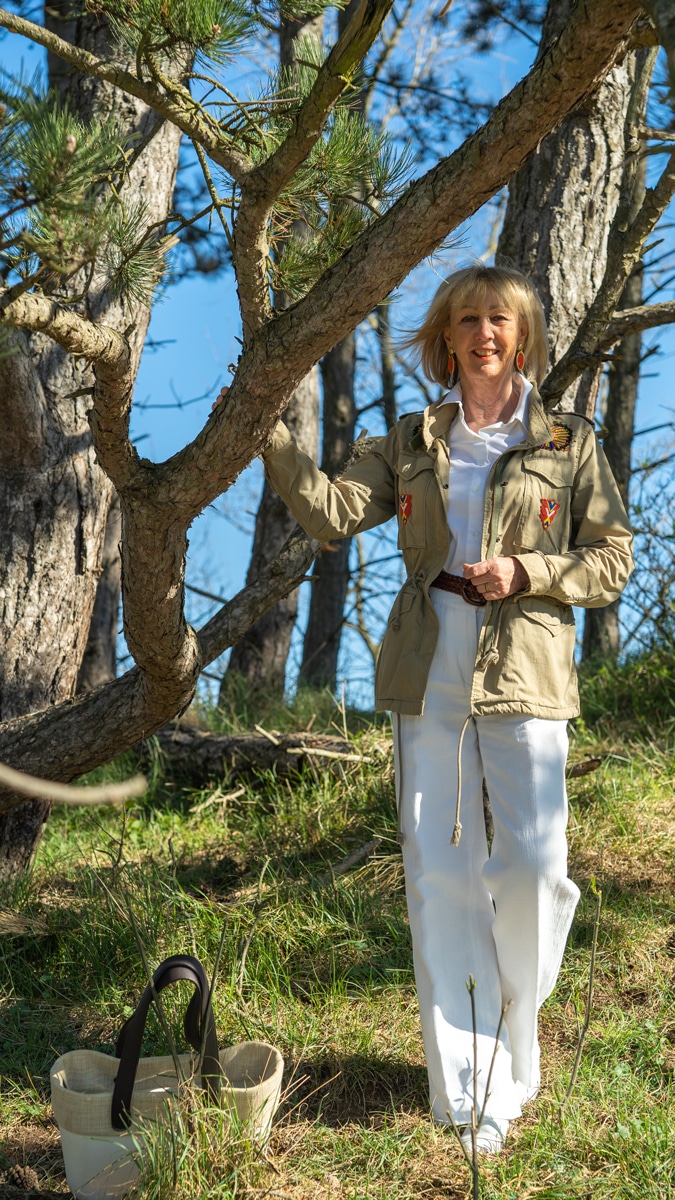White trousers and shirt with a green jacket