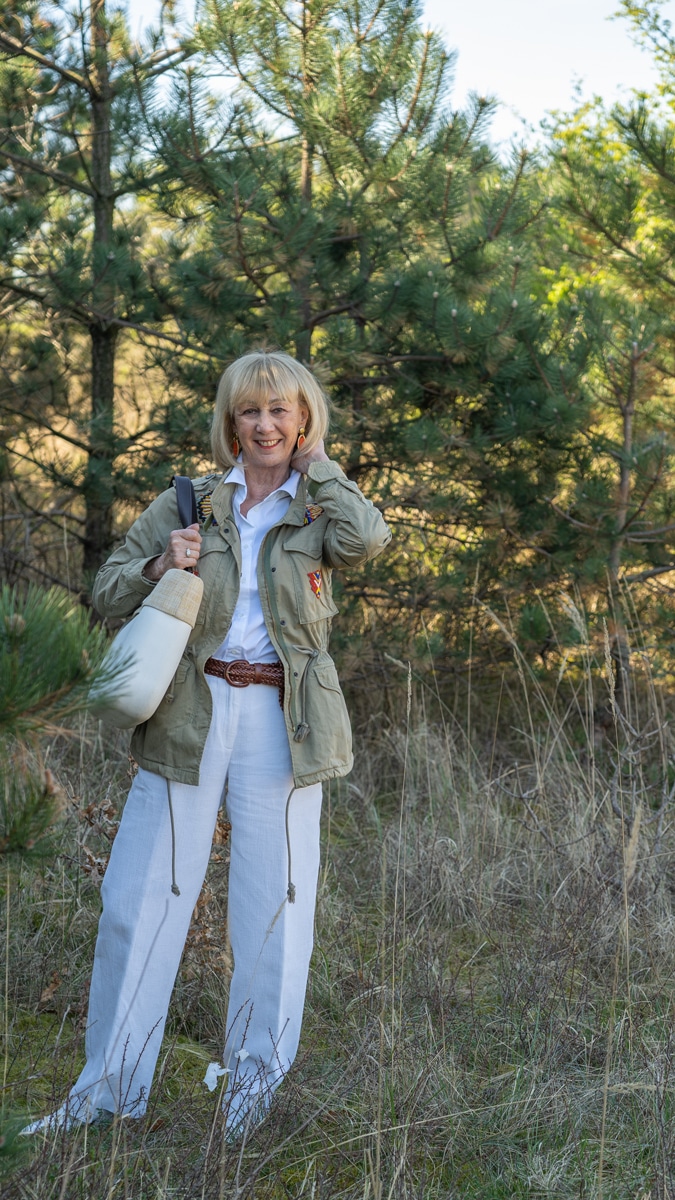 White trousers and shirt with a green jacket