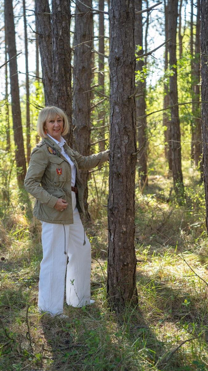 White trousers and shirt with a green jacket