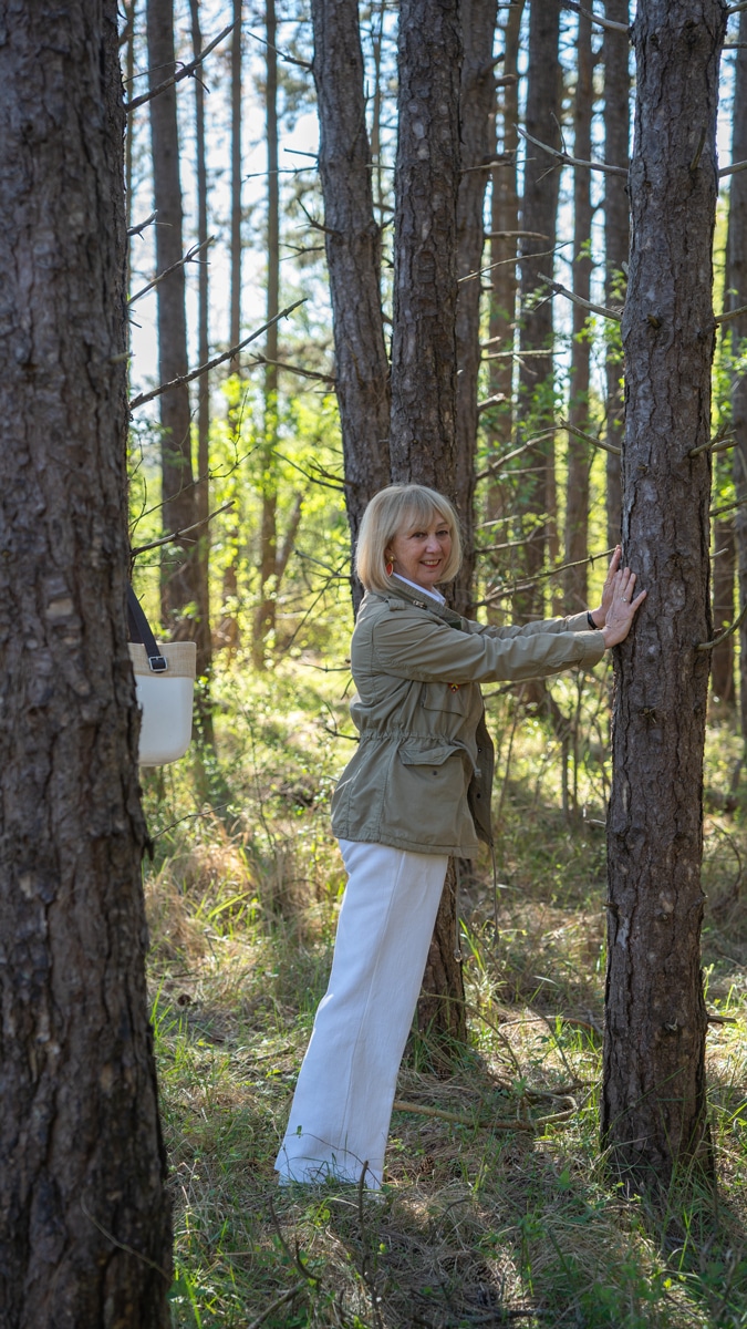 White trousers and shirt with a green jacket