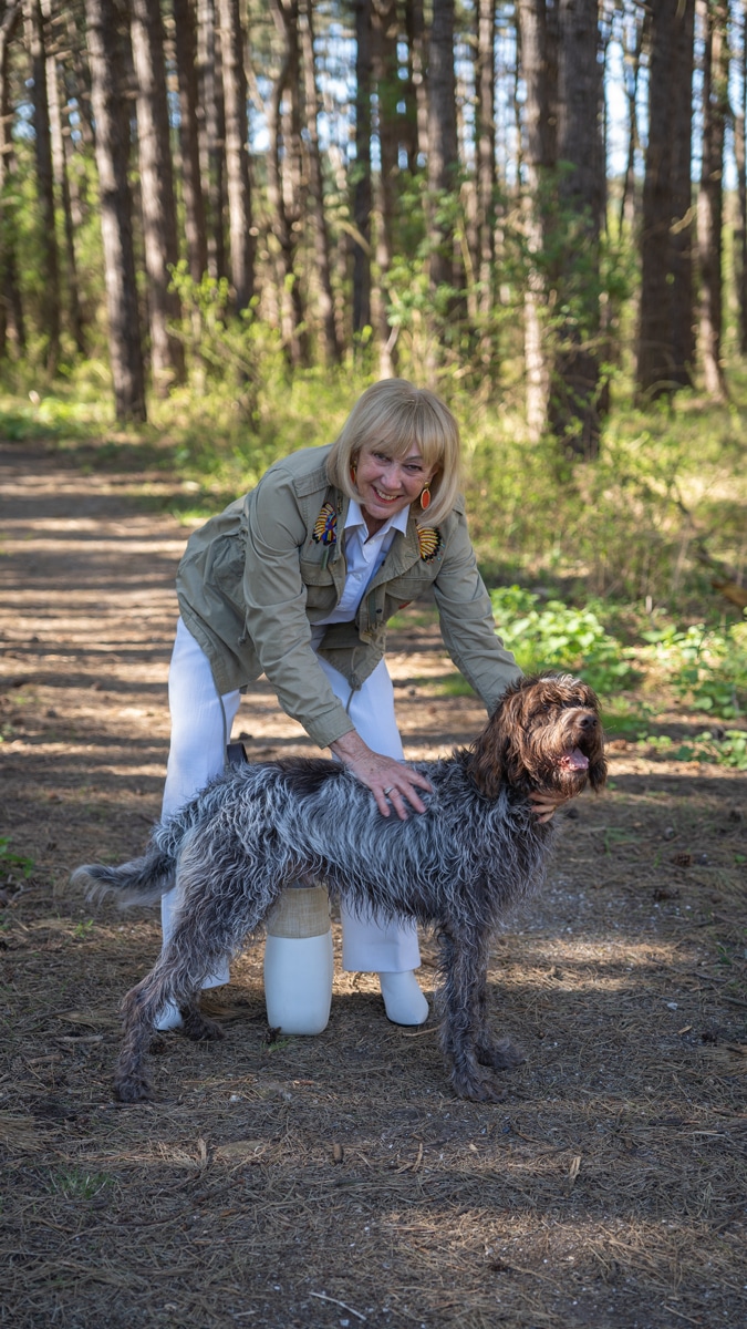 White trousers and shirt with a green jacket