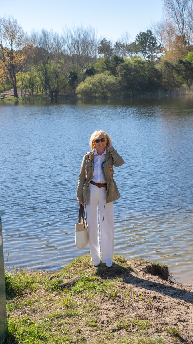 White trousers and shirt with a green jacket