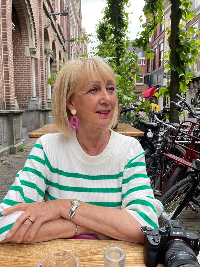 Green and white striped jumper and pink earrings