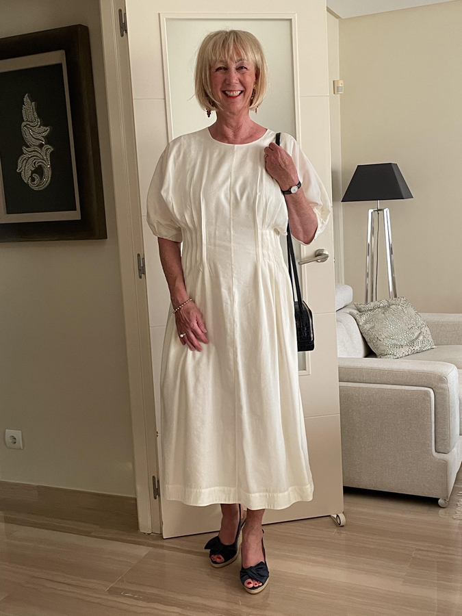 In a cream coloured COS dress