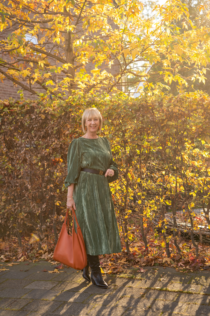 Green dress with black belt and black boots