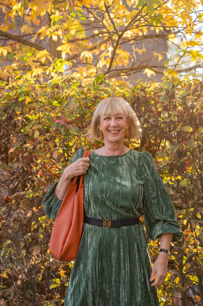 Green dress with black belt and black boots