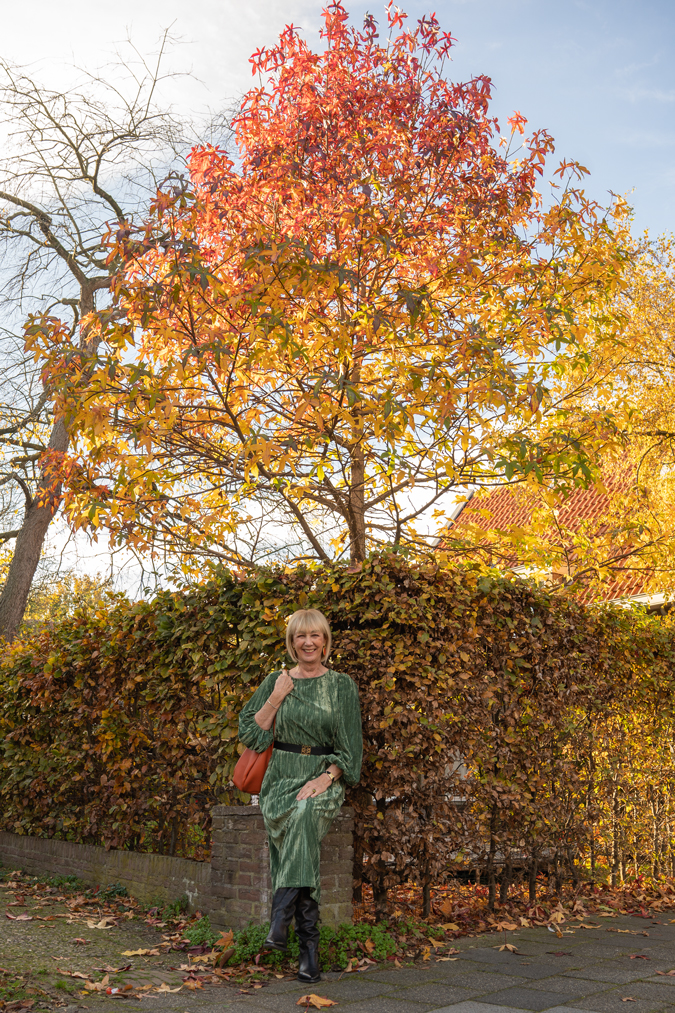 Green dress with black belt and black boots